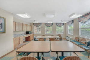 community room with tables and chairs, microwave