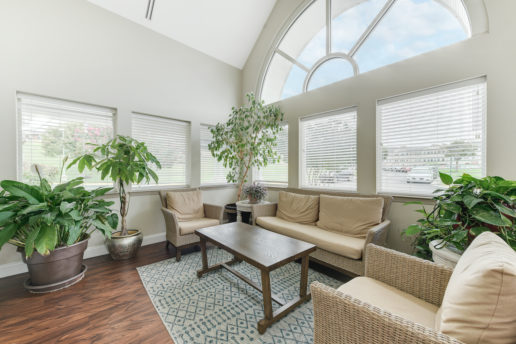 bright community room with large window and seating area